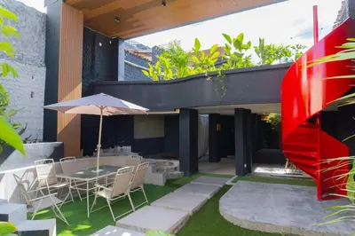 a patio with a table and chairs and an umbrella at Casa Tuti Laureles in Estación El Salto