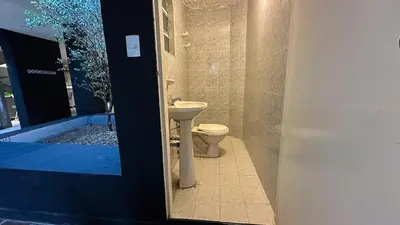 a bathroom with a toilet and a sink at Casa Tuti Laureles in Estación El Salto