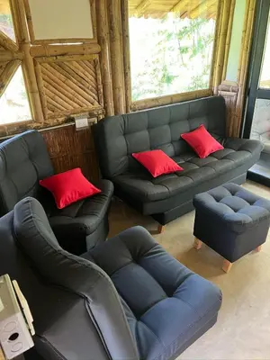 a living room with a couch and red pillows at Cabaña vip familiar vista verde in Cocorná