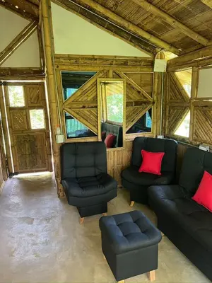 a living room with couches and chairs in a barn at Cabaña vip familiar vista verde in Cocorná