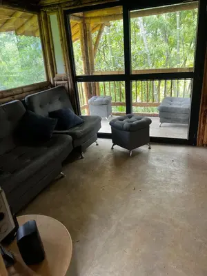 a living room with a couch and a table at Cabaña vip familiar vista verde in Cocorná