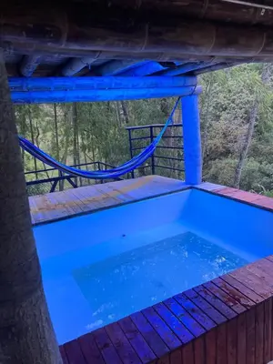 a plunge pool on the deck of a tree house at Cabaña vip familiar vista verde in Cocorná