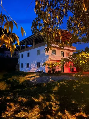 a building with a tree in front of it at Casa compartida - Las 5 Quintas in San Rafael