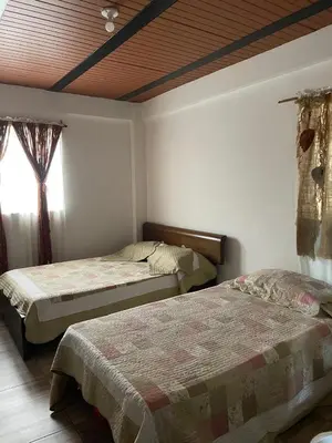 a bedroom with two beds and a window at Casa compartida - Las 5 Quintas in San Rafael