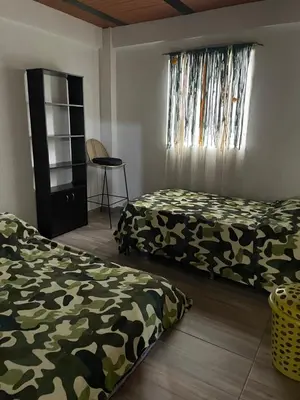a bedroom with two beds and a window at Casa compartida - Las 5 Quintas in San Rafael