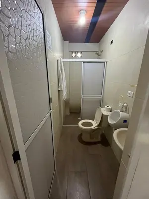 a bathroom with a toilet and a sink at Casa compartida - Las 5 Quintas in San Rafael