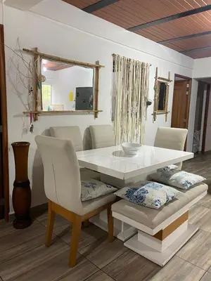 a dining room table and chairs with a white table and a mirror at Casa compartida - Las 5 Quintas in San Rafael