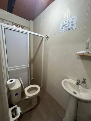 a bathroom with a toilet and a sink at Casa compartida - Las 5 Quintas in San Rafael