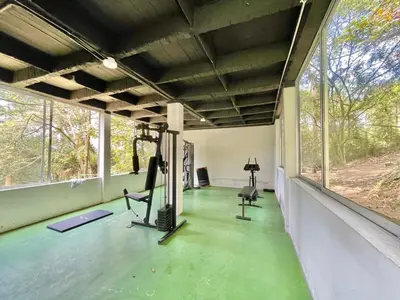 an empty gym with two treadmills and a large window at medellín palmas sandiego 2 in Medellín