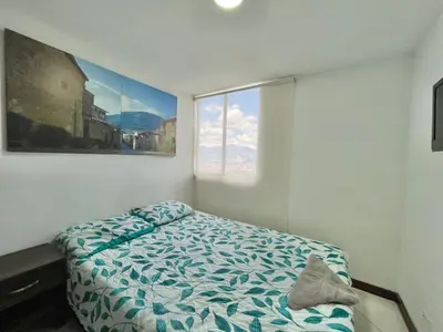 a bedroom with a bed and a large window at medellín palmas sandiego 2 in Medellín
