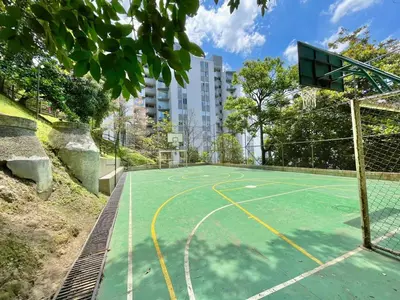 a tennis court with a basketball hoop in a city at medellín palmas sandiego 2 in Medellín