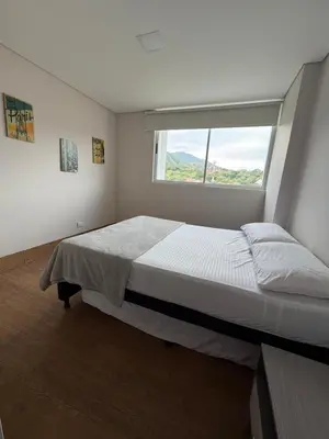 a bedroom with a large bed with a window at Apto Citadela Di Sole in Santa Fe de Antioquia