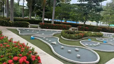 a row of artificial reservoirs in a park with flowers at Apto Citadela Di Sole in Santa Fe de Antioquia