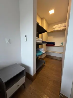 a walk in closet with a bench in a room at Apto Citadela Di Sole in Santa Fe de Antioquia
