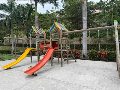 a playground with three slides and a swing at Apto Citadela Di Sole in Santa Fe de Antioquia