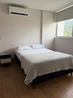 a white bedroom with a bed and a window at Apto Citadela Di Sole in Santa Fe de Antioquia