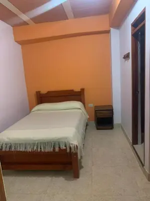 a bedroom with a bed in a room at Casa Hotel La Cascada