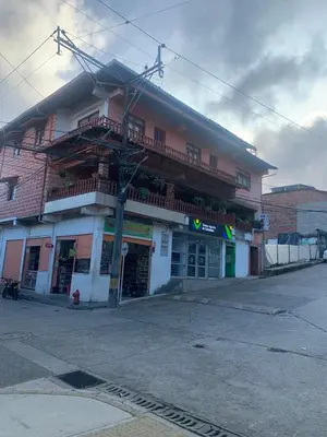 a building on a street in front of a building at Casa Hotel La Cascada
