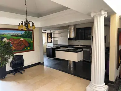 a kitchen with a column in the middle of a room at Penthouse Rio Claro 1002 in Medellín