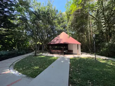 a gazebo with a red roof in a park at Penthouse Rio Claro 1002 in Medellín