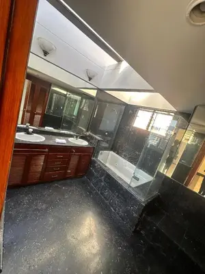 a bathroom with two sinks and a shower and a mirror at Penthouse Rio Claro 1002 in Medellín
