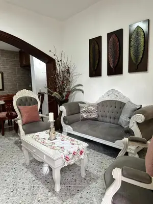 a living room with a couch and a coffee table at Casa espaciosa cerca al estadio in Medellín