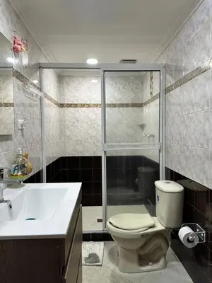 a bathroom with a shower and a toilet and a sink at Casa espaciosa cerca al estadio in Medellín