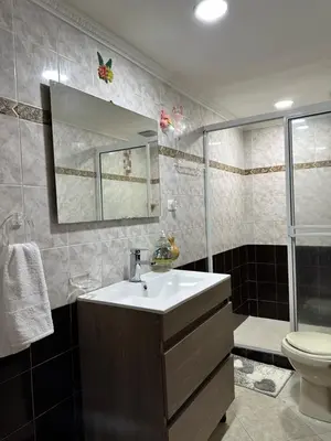 a bathroom with a sink and a toilet and a mirror at Casa espaciosa cerca al estadio in Medellín