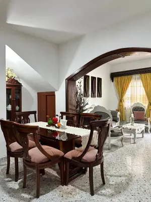 a living room with a table and chairs at Casa espaciosa cerca al estadio in Medellín