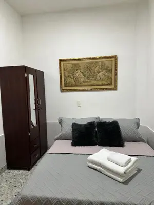 a bedroom with a bed with a picture on the wall at Casa espaciosa cerca al estadio in Medellín