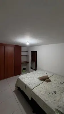 a bedroom with a bed with a towel on it at Acogedora casa ideal para familias y grupos cerca al estadio barrio Laureles la América in Medellín