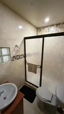 a bathroom with a toilet and a sink at Acogedora casa ideal para familias y grupos cerca al estadio barrio Laureles la América in Medellín