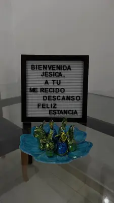 a table with some green glass figurines on it at Acogedora casa ideal para familias y grupos cerca al estadio barrio Laureles la América in Medellín