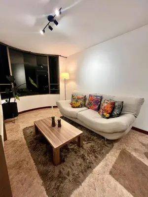 a living room with a couch and a coffee table at Cozy apartment with panoramic views in Manizales