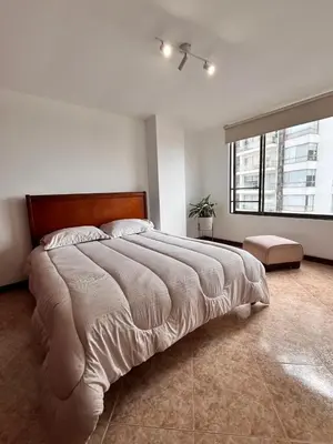 a large bed in a bedroom with a large window at Cozy apartment with panoramic views in Manizales