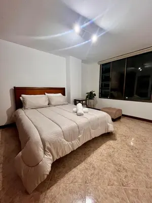 a bedroom with a large bed with a ceiling at Cozy apartment with panoramic views in Manizales