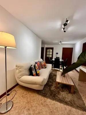 a living room with a couch and a table at Cozy apartment with panoramic views in Manizales