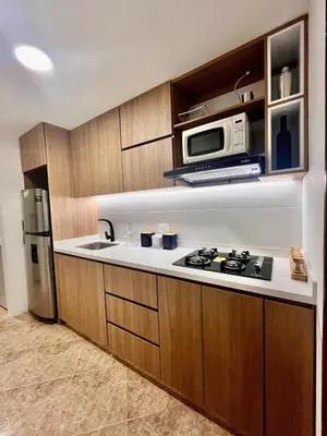 a kitchen with a stove and a microwave at Cozy apartment with panoramic views in Manizales