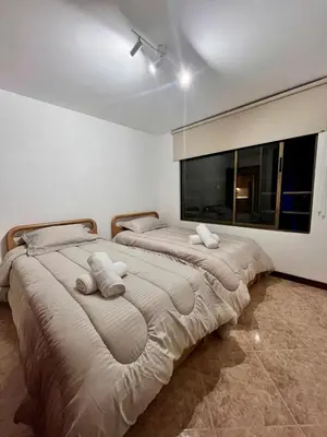 two beds sitting next to each other in a bedroom at Cozy apartment with panoramic views in Manizales