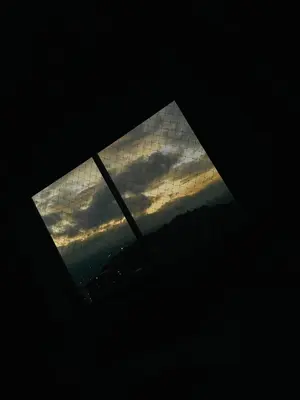 a window with a view of a cloudy sky at Apartment near Atanasio Girardot Stadium in Medellín