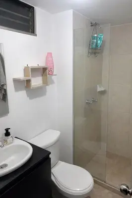 a bathroom with a shower with a toilet and a sink at Apartamento cerca del estadio de Medellín in Medellín