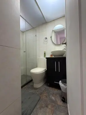 a bathroom with a toilet and a sink and a mirror at Happy home in Guayaquil