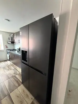 a stainless steel refrigerator in a kitchen at Happy home in Guayaquil