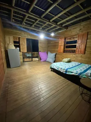 a bedroom with a bed in a wooden room at Refugio de Sueños in San Rafael