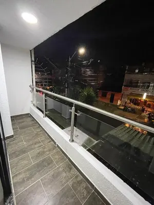 a balcony with a view of a city at night at Smart apartment in Bello