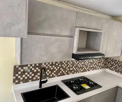a small kitchen with a sink and a stove at Smart apartment in Bello
