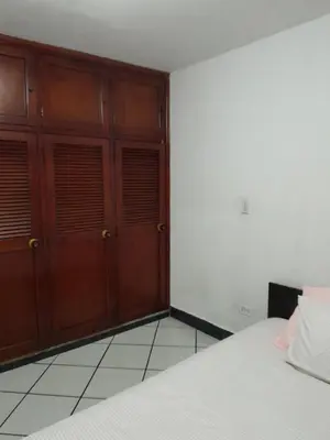 a bedroom with two wooden doors and a bed at Abis in Medellín