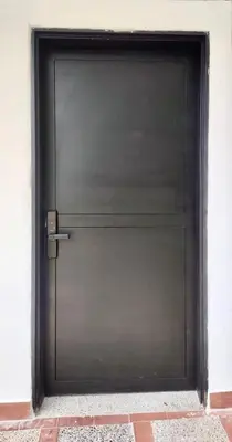 a large metal garage door in a building at Acogedor y cómodo loft Medellín cerca al Estadio in Medellín