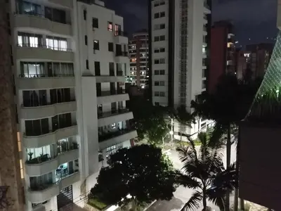 a view of a city at night with buildings at Apartahabitacion Laureles in Medellín