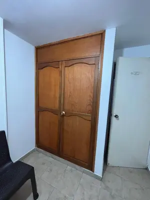 a wooden door in a room with a chair at Casa Minca in Medellín